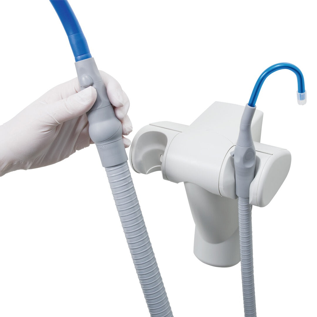 Dental suction manifold by Durr dental pictured with a gloved hand holding the large tip.