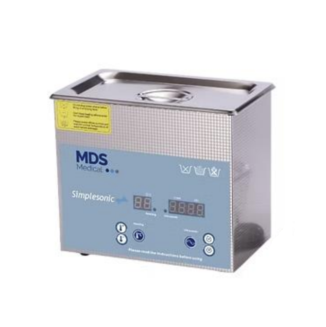 An MDS Ultrasonic Cleaner, model Simplesonic, shown at a three-quarter angle on a white background. The device has a silver metallic body, a light blue front control panel with digital displays and buttons, and a yellow warning label on the top left.